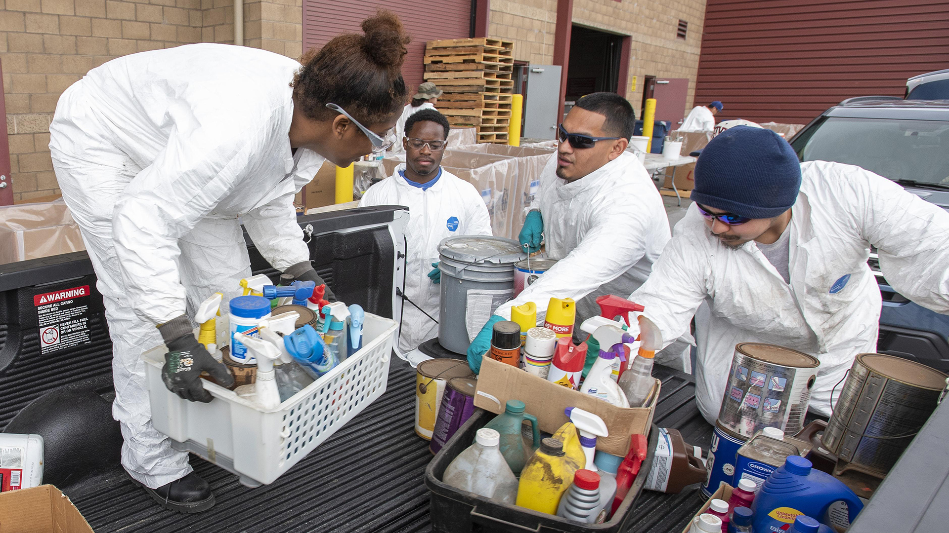 Photo of staff unloading household hazardous waste at a collection event.