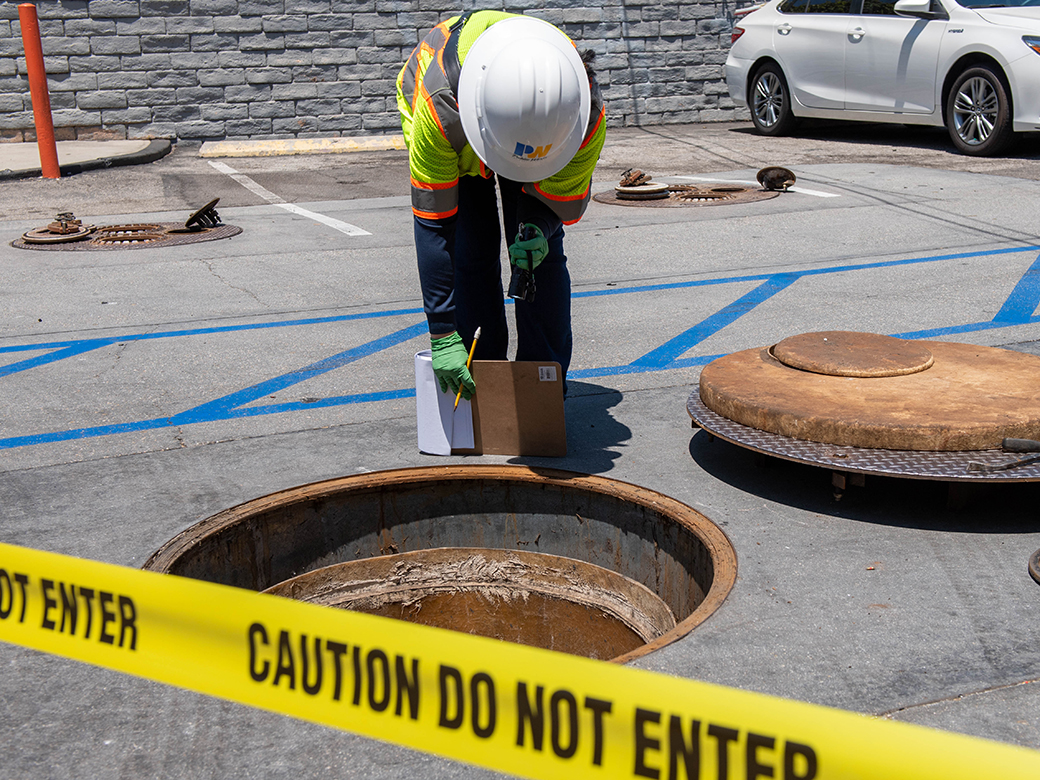 An inspector performs an underground storage tank inspection.